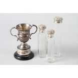 A silver two-handled trophy, on stand, three silver mounted toilet jars (one with damaged neck), 5oz