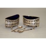 A pair of silver plated salts with pierced decoration, a pair of silver salt spoons and a silver