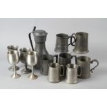 A number of pewter jugs, tankards, etc