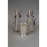 Two silver plate mounted claret jugs with applied decoration, largest 11" high, and a plated tankard