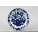 An early 18th century Dutch delft dish with vase and floral centre, 13 1/2" dia (stapled)