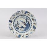 An early 18th century Bristol blue and manganese charger with bird and fence design, 13 1/2" dia