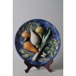 A Palissy style wall plaque with vegetables in high relief, 12" dia