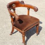 A mid Victorian oak and ivory inlaid desk elbow chair with fern carved terminals, on faceted