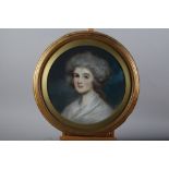 A mid 18th century pastel portrait of an unknown woman with powdered hair, 16 1/2" dia, in gilt