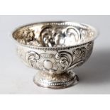 A white metal pedestal bowl with embossed figure and landscape decoration, 3.6oz troy approx