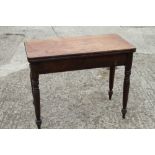 A 19th century mahogany fold-over top tea table, on turned supports, 36" wide x 18" deep x 28 1/2"