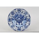 An early 18th century Dutch delft "Kraak" charger with vase of flowers centre, 13 3/4" dia (hair c