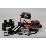 A pair of Vickers 10x42 binoculars, two Minolta pocket cameras, two other cameras and a number of