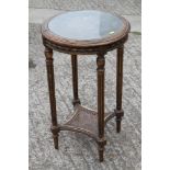 A late 19th century carved giltwood circular top occasional table, on fluted supports united by a