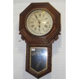 An American oak cased octagonal faced drop dial regulator clock with Arabic numerals on enamelled