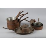 Eight copper saucepans, various sizes