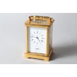 An Asprey & Garrard brass cased hour repeater carriage alarm clock with white enamel dial and