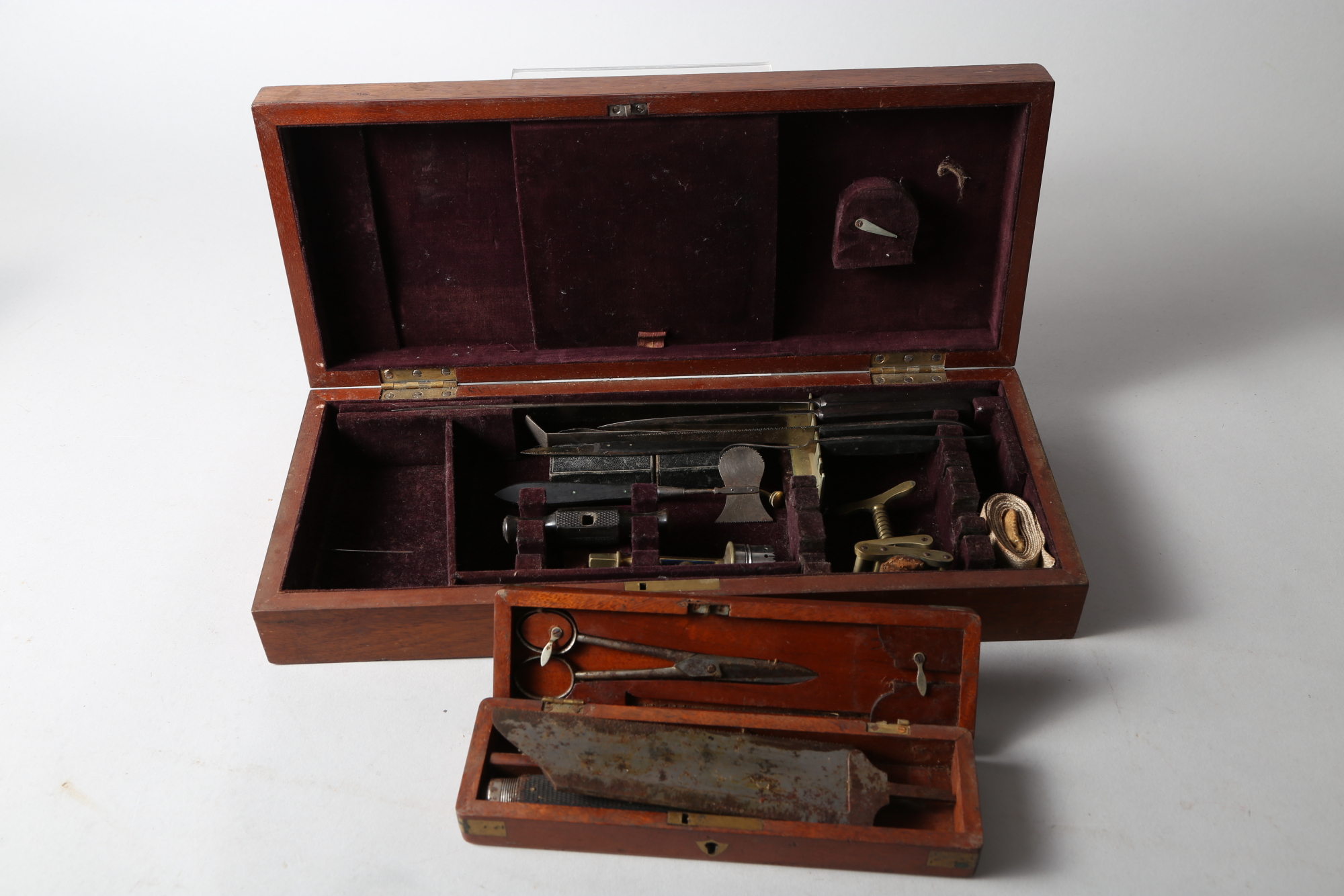 A surgeon's 19th century amputation saw, in case, together with an amputation set, in case