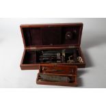 A surgeon's 19th century amputation saw, in case, together with an amputation set, in case
