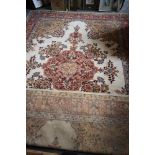 A wool pile rug of traditional Persian design in shades of brown, tan, blue and natural, 49" x
