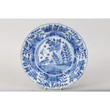 An early 18th century Dutch? delft charger with swan and plant centre, 13 3/4" dia (restored rim)
