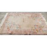 A Chinese wool contour pile rug with floral design and character centre, 67" x 96" approx (small