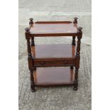 A late Victorian mahogany three-tier buffet/whatnot, fitted one drawer, on turned and castored