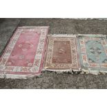 Two Chinese contour pile wool rugs with character borders and a larger similar rug, largest 31" x