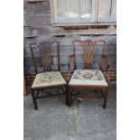 A Georgian carved mahogany elbow chair of Chippendale design with pierced splat and needlepoint