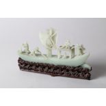 A Chinese carved jade model of a sampan with five crew (restored), on wave carved hardwood stand,