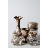 A pair of silver mounted glass inkwells, a silver mounted smelling salts jar, a silver baluster