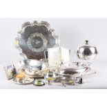 A silver plated pie crust salver, a plated entree dish and cover, a plated tea caddy, a plated