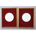 A pair of Copenhagen bisque porcelain relief moulded panels, in gilt frames