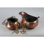 A pair of brass candlesticks, formed as cobras, 5 1/4" high, a copper coal scuttle and a copper pot