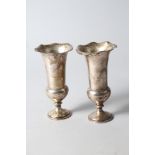 A pair of silver trumpet vases with flared waved rims and weighted bases