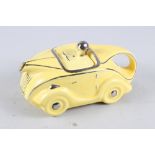 A 1930s Sadler yellow glazed sports car teapot, 9" long