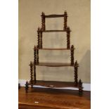 A mid Victorian rosewood serpentine five-tier whatnot, on barley twist supports and turned feet, 30"