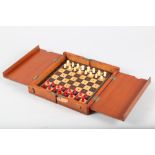 A 19th century mahogany cased travelling chess set with turned bone pieces, 8" square (damages)