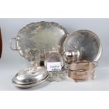 A silver plated two-handled serving tray, a plated circular tray, a plated egg warmer, a plated