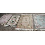 Four Chinese contour pile wool rugs with floral designs, largest 31 1/2" x 60" approx