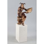 † Ian Norbury: a carved lime and other woods with copper figure, "The Bureaucrat", 11" high, on