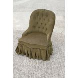 A 19th century low seat chair, button upholstered in a green corduroy, on turned supports, and a