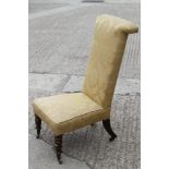 A late Victorian rosewood framed prie-dieu, upholstered in an old gold brocade