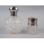 A silver topped scent bottle and a silver topped smelling salts bottle (chipped and cracked)