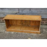 A pine low open book rack, on block base, 45" wide