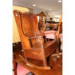 An 18th century oak 'Cheshire' lambing rocking chair with panel seat over single drawer