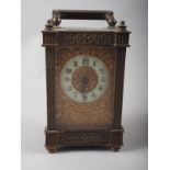 An early 20th century carriage clock with pierced and gilt decoration, 5" high
