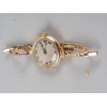 A lady's 18ct gold cased wristwatch with silvered dial and Roman numerals, 21.6g gross, on yellow