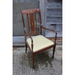 An Edwardian line inlaid mahogany open armchair with drop-in seat, upholstered in a gold fabric