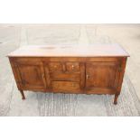 A late 19th century oak sideboard, fitted three drawers and flanking cupboards enclosed panelled