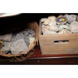 A collection of geological specimens, fossil fragments and a hammer, in wicker baskets