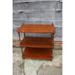 A mahogany three-tier whatnot, on bun feet, 28" wide x 15" deep x 31" high