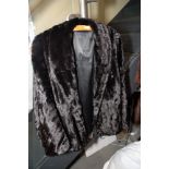 A dyed black ermine jacket (damages) and a quantity of fur stoles, gloves, etc