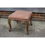 A carved walnut stool with padded seat, on cabriole supports, 15" square x 19" high, and a pair of